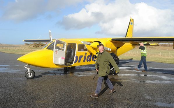 A passenger disembarks at Coll.