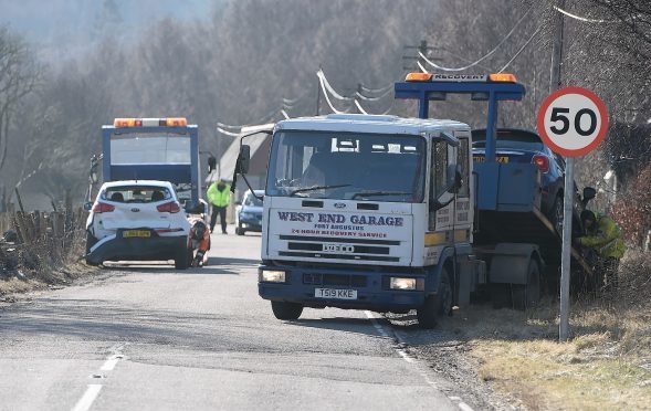 Vehicles are recovered from the scene of the crash on the A887