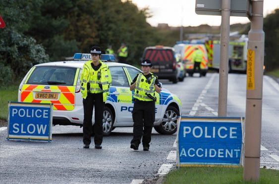 Police officers on the scene of the crash