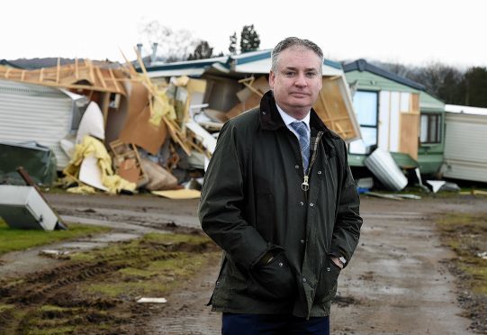 The environment secretary, Richard Lochhead on a visit to Ballater to check the flood damage, In the picture is Richard Lochhead at the caravan park, Ballater. 
Picture by Jim Irvine  4-3-16