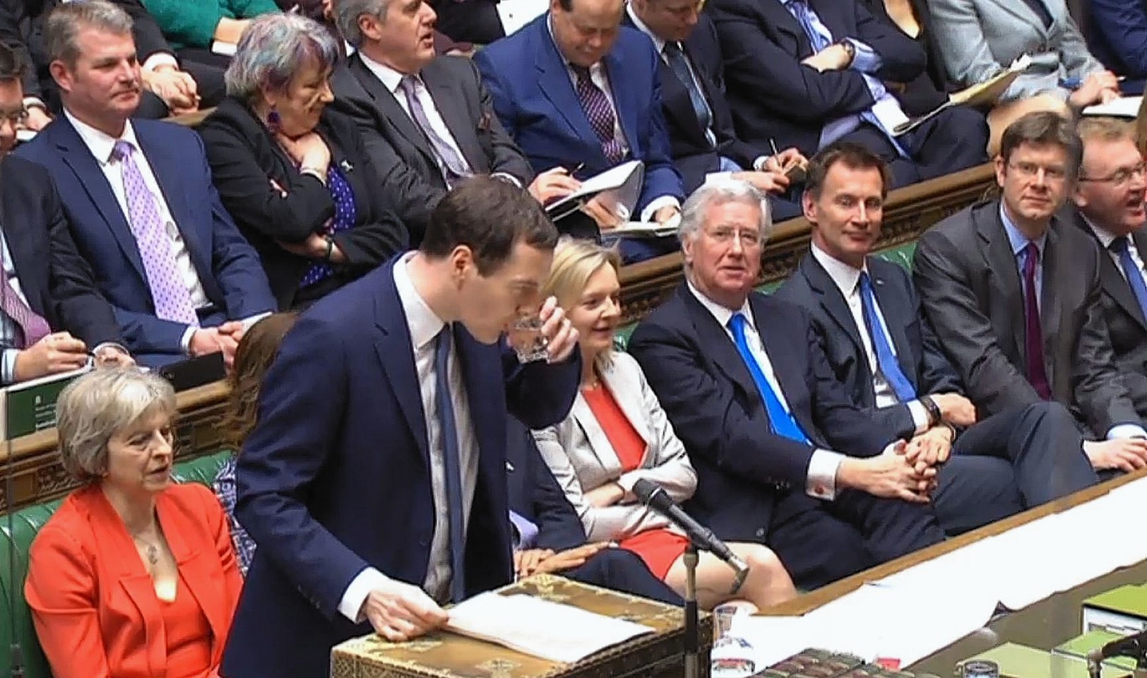 Chancellor of the Exchequer George Osborne pauses for a drink as he delivers his Budget statement to the House of Commons