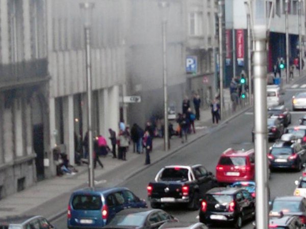 Commuters flee the Metro station after a third explosion