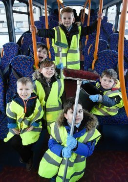 Charlie Thomson (front left) of North Kessock with some of his classmates from North Kessock Primary School as they clean a Stagecoach Bus in Inverness to raise funds to buy specialist equipment for Charlie.