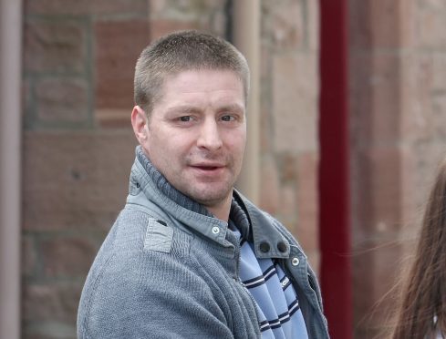 Scott Mackinnon leaving Inverness Sheriff Court, where he was sentenced to 30 months for breaking Yvonne Davies' arm.