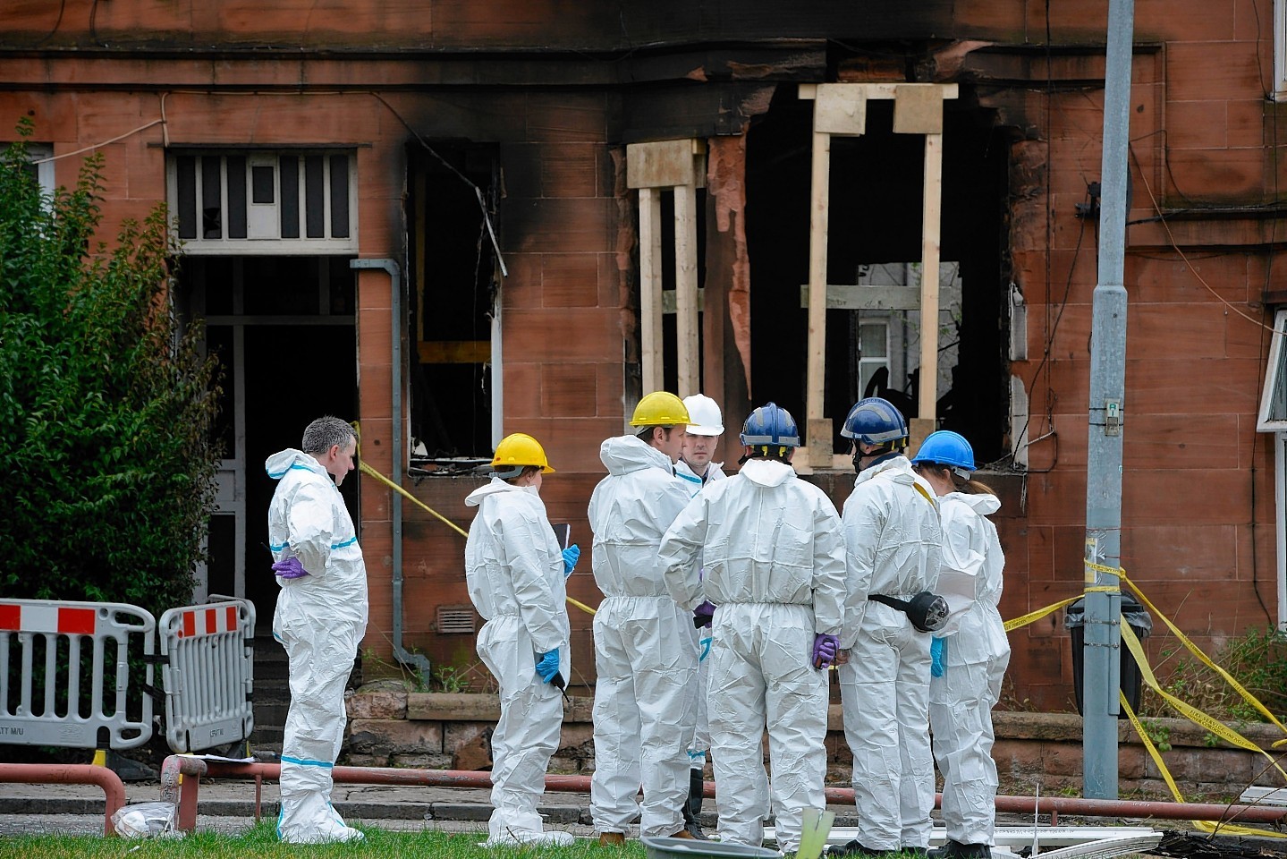 Forensic teams inspects the scene of the blaze 