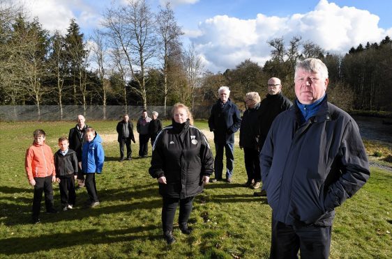 Kemnay residents with Ken Leddingham (right) at the gap in the bund at Kembill Park which they want the council to fix after water flooded the houses there. 
Picture by KEVIN EMSLIE