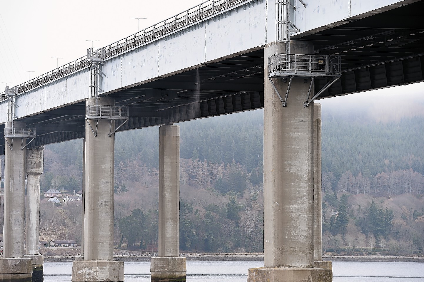 Water pours under pressure from a water pipe beneath the Kessock Bridge