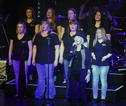 Lulu performs on stage with the Military Wives Choir earlier this year. The group have attracted another star performer
