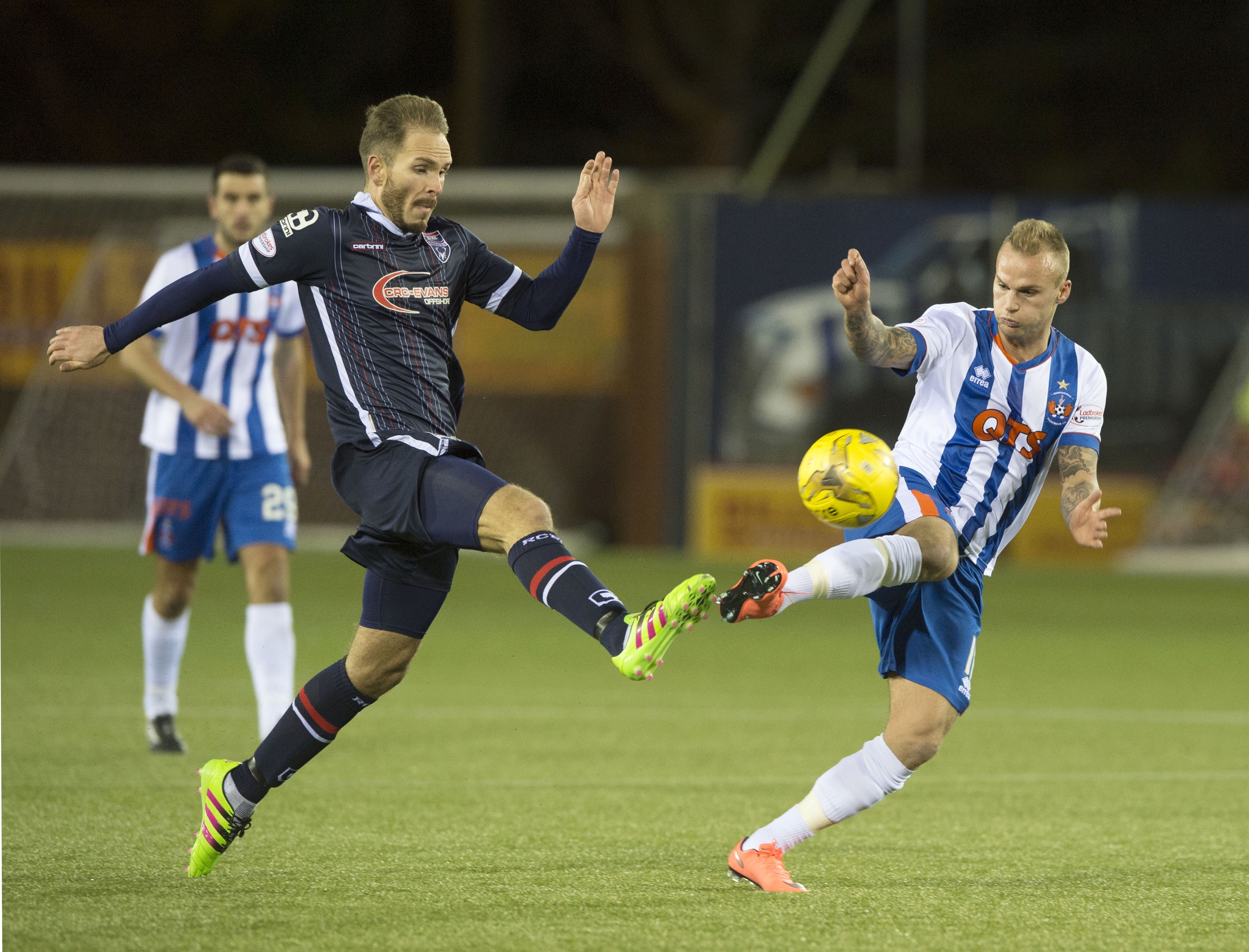 Ross County's Martin Woods (left) battles for the ball against Kilmarnock's Kallum Higginbotham