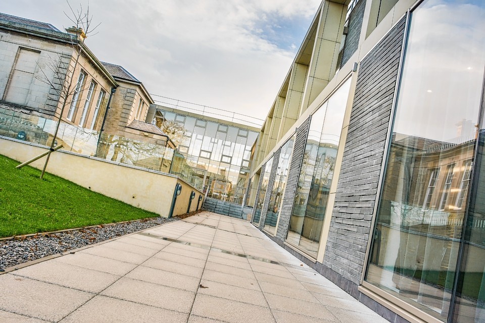 A decision by UHI Moray to celebrate the 10 year anniversary of the Alexander Graham Bell Centre when 45 staff are expected to lose their jobs has been called 'tone deaf' by a lecturers' union.