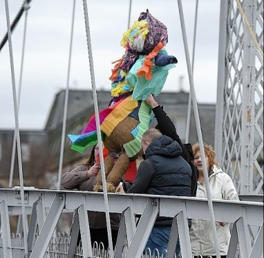 Pupils and parents from the Polish Saturday School in Inverness prepare to throw the doll off the bridge