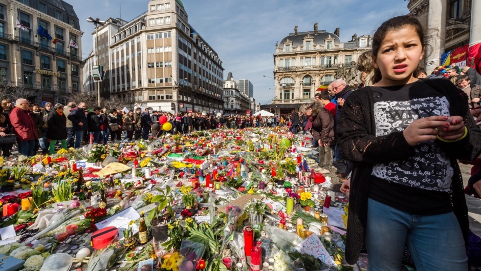 Floral tributes line a memorial site at the Place de la Bourse in Brussels (AP)