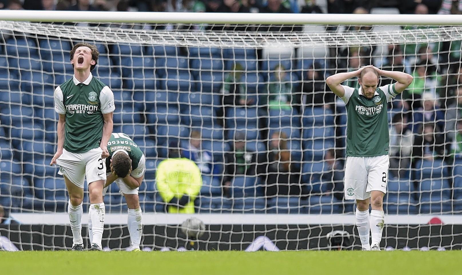 Dejection for Hibernian's Liam Henderson (left), Darren McGregor (centre) and David Gray after conceding a late second goal in the League Cup final 