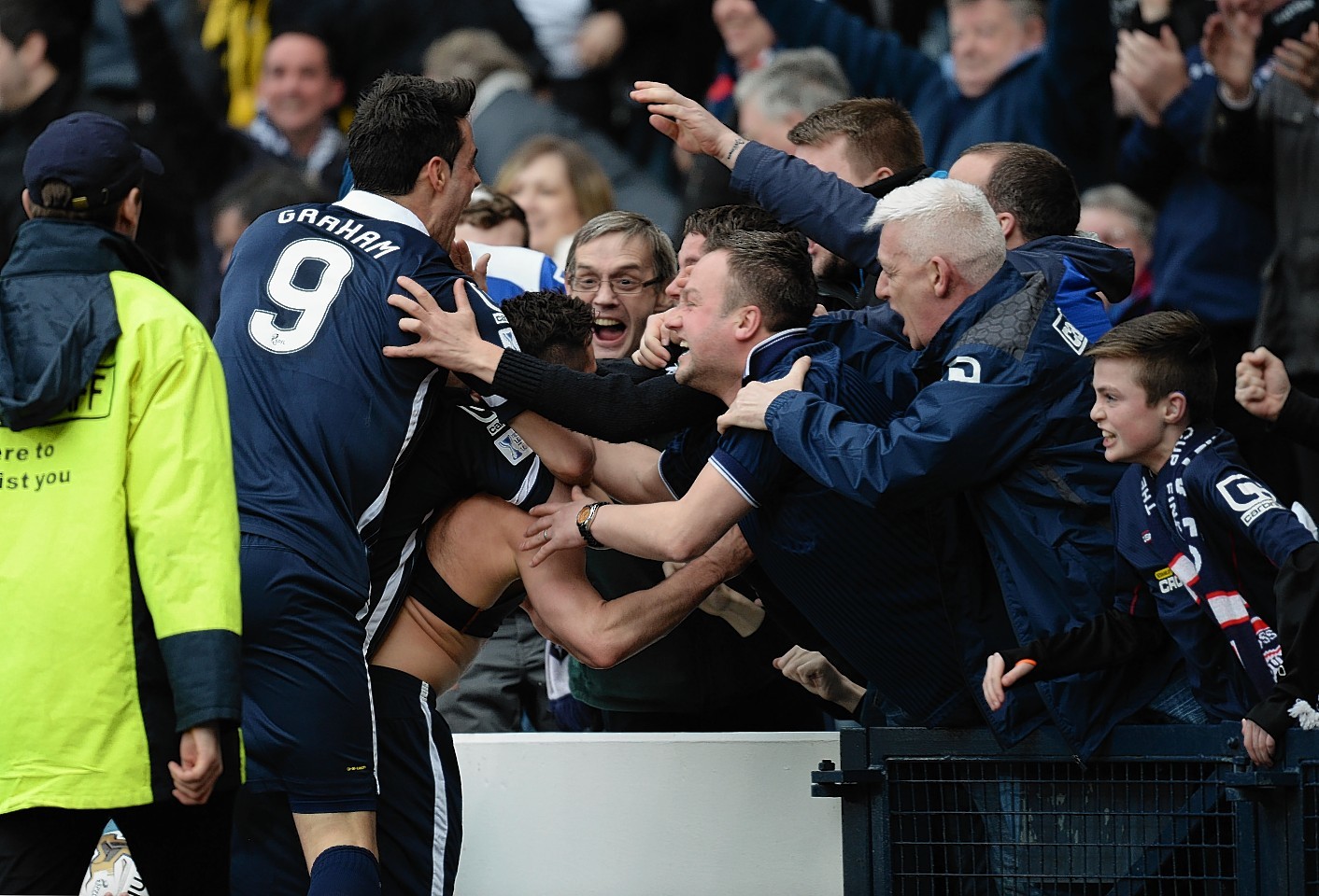 Ross County's Alex Schalk celebrates his winning strike with Staggies fans and team mates 