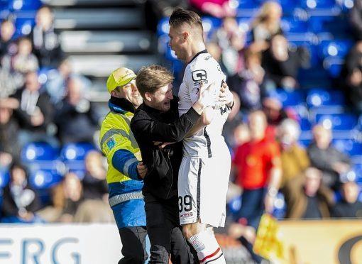 Storey celebrates the goal with a Caley Thistle fan