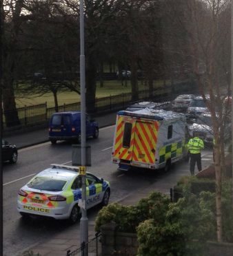 Police officers and ambulance crews on the scene of the crash