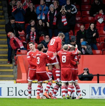 The Dons celebrate Simon Church's opening goal