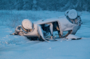 Snow covers an abandoned overturned car on A703 in Waterhead, Midlothian