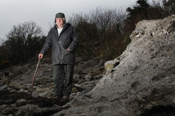 Donald Robertson at the flood defences near his croft in Milton of Culloden. Picture: Andrew Smith