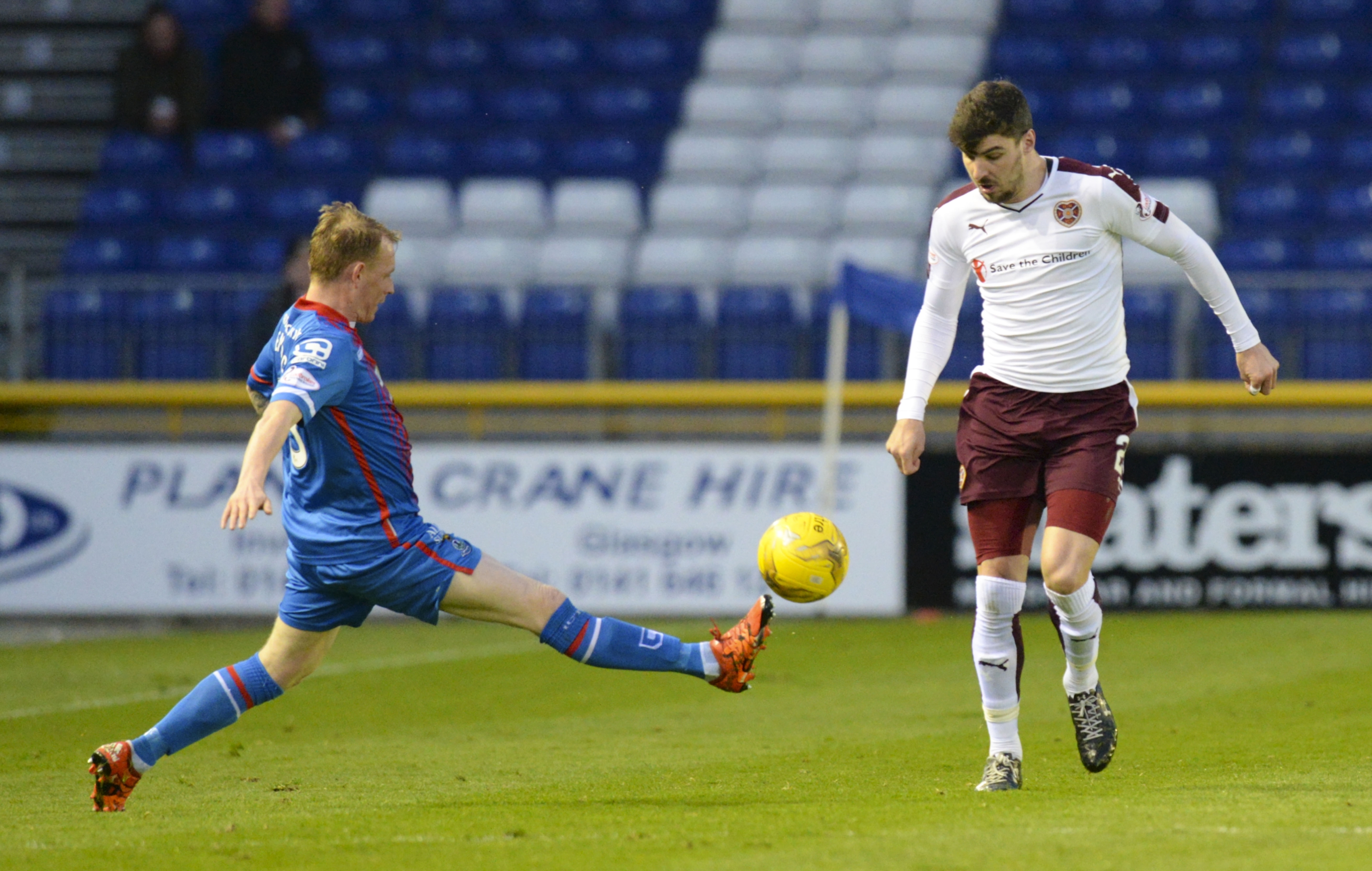 Hearts' Callum Paterson is challenged by Carl Tremarco