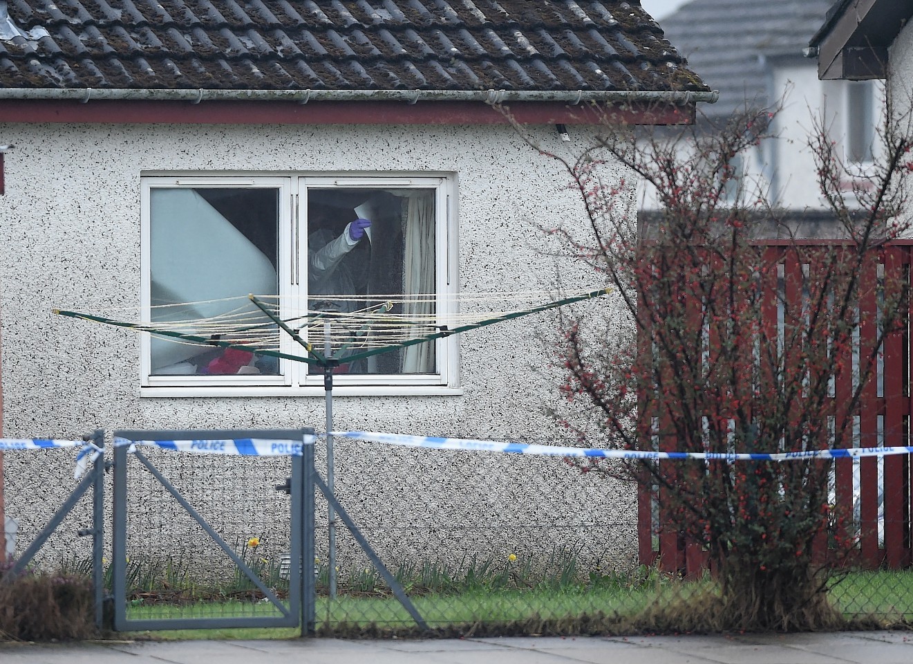 Forensic officers at work in the home of Elizabeth Mackay in Kintail Court, Inverness