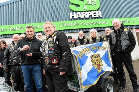 Stuart Harper, front left, hands over keys to Donna Lockyear, Royal British Legion Scotland Riders Branch