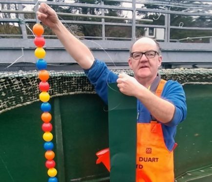 Loch Duart hatchery worker Hugh Ross with some of the toys