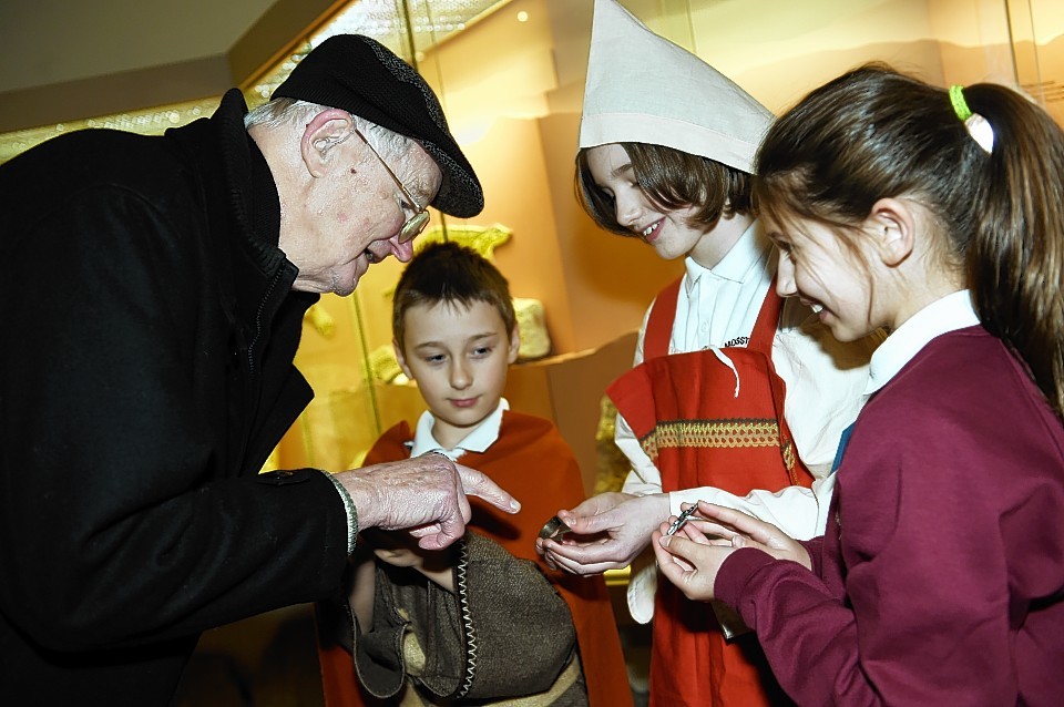 Visitor, John Forgie, is shown Viking artefacts by pupils Tyler Green, Carla Burnett and Mollie Grierson. Picture by Gordon Lennox