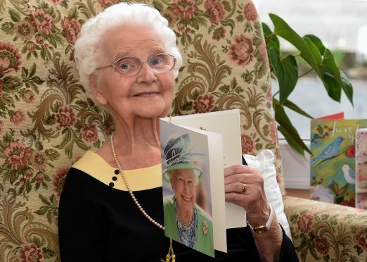 Nan Milton with her card from the Queen