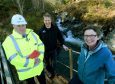 Charlie Gallagher (left), with Peter MacFarlane and Marian Austin at the burn which which will provide hydro power