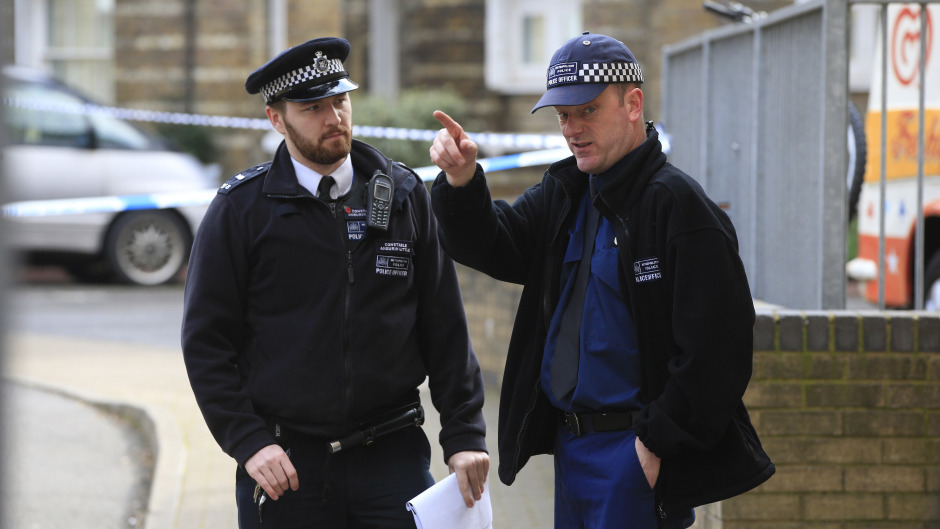 Two police officers at the entrance to the Southwark Street Estate in south London, where the remains of Pc Semple were found