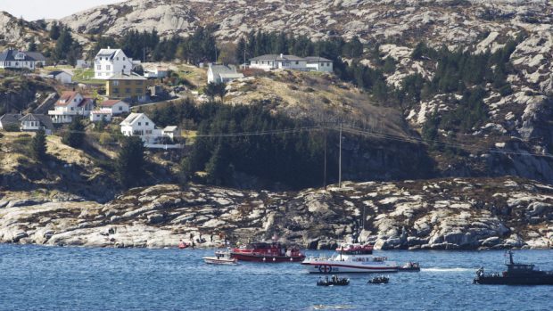 A search and rescue vessel patrols off the island of Turoey, near Bergen, Norway, as emergency workers attend the scene of a helicopter crash (Marit Hommedal/NTB scanpix via AP)
