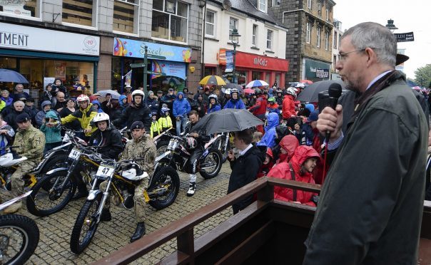 Councillor Thomas MacLennan welcomes riders at the start of a previous Scottish Six Days Trial in Fort William High Street