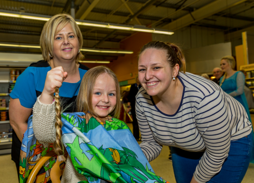 Madison with her new 'do, alongside her hairdresser Christine Allan(left) and mum Carrie Lynch (right)