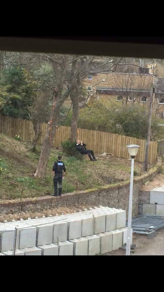 Policeman playing on the rope swing in Aberdeen