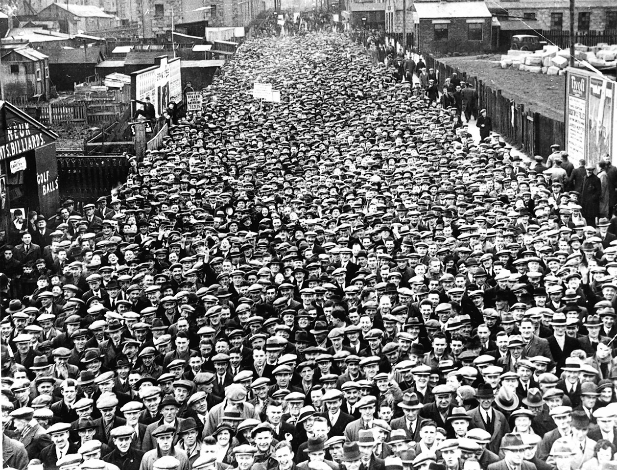 Fans marching towards Pittodrie for a game against Celtic in the 1930s.