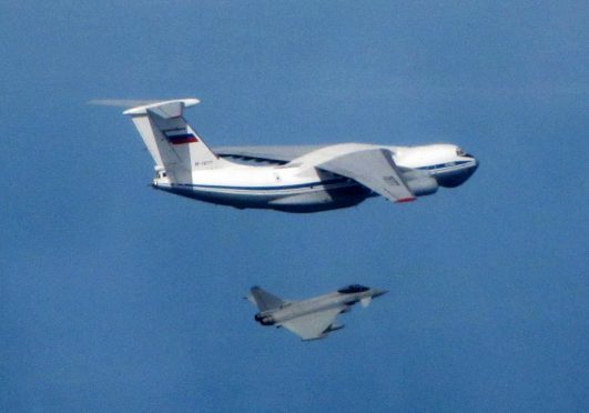Russian IL76 Candid aircraft, being shadowed by a RAF Typhoon (bottom).