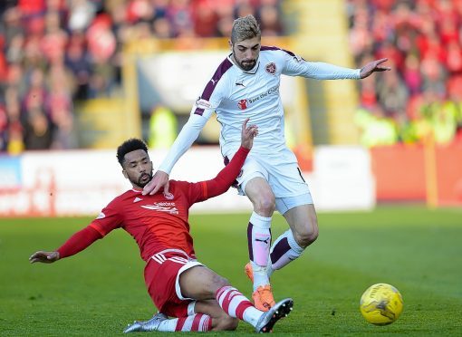 Aberdeen's Shay Logan (left) with the challenge on Hearts' Juanma Delgado