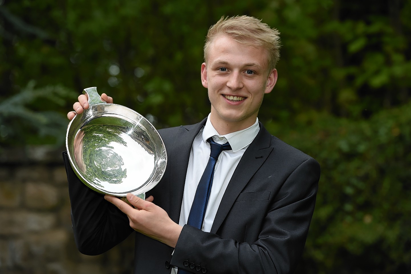 Harry Milne proudly displays his award