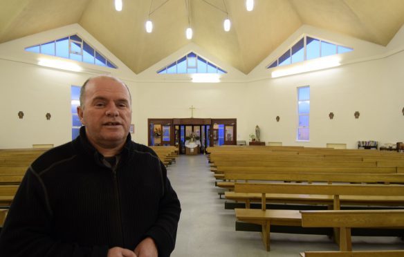 Father Roddy McAuley in the church where the new window will be installed above the door