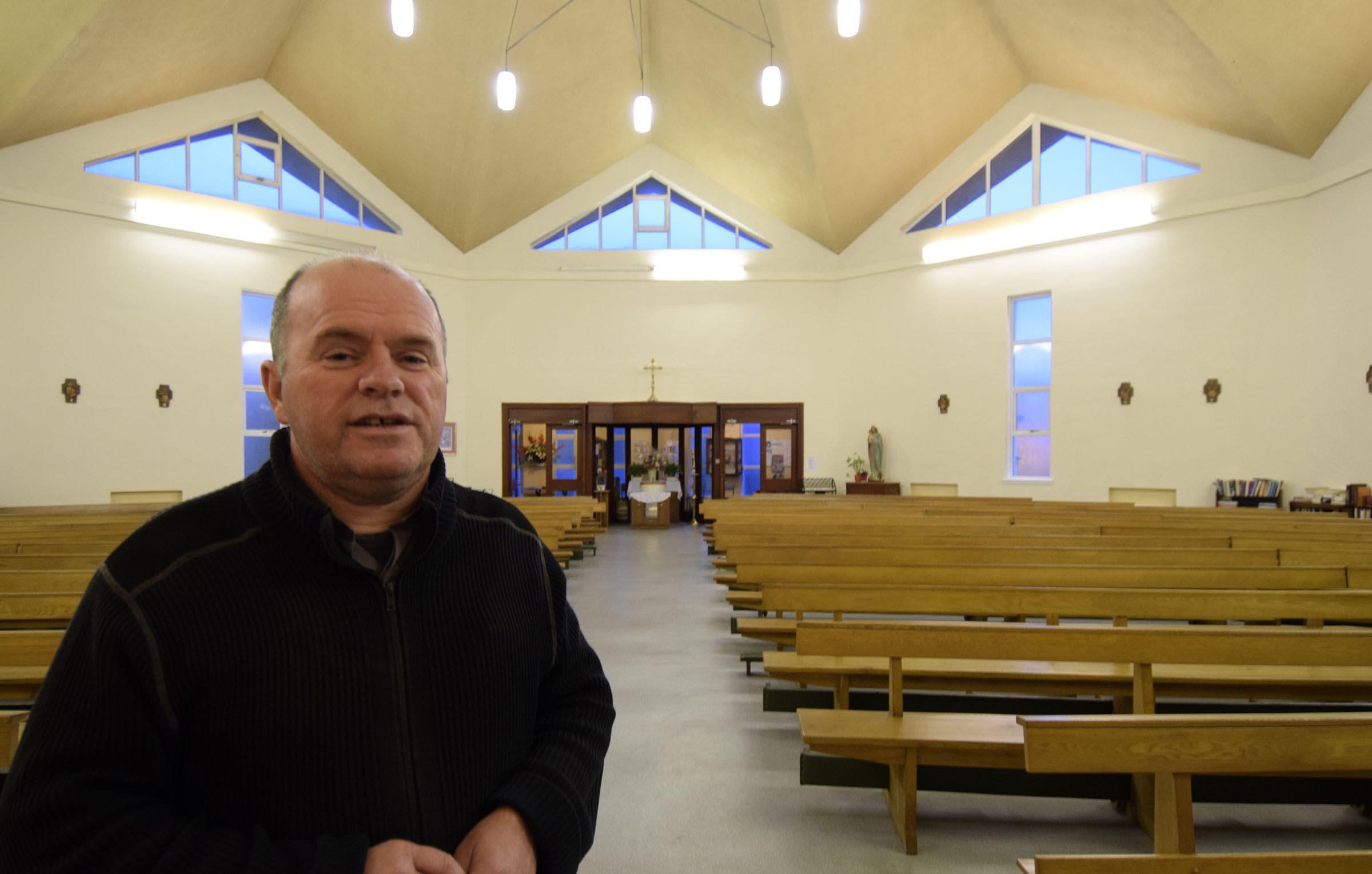 Father Roddy McAuley in the church where the new window will be installed above the door