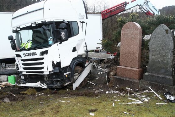 The cab of the articulated lorry which crossed the carriageway and demolished the cemetery wall