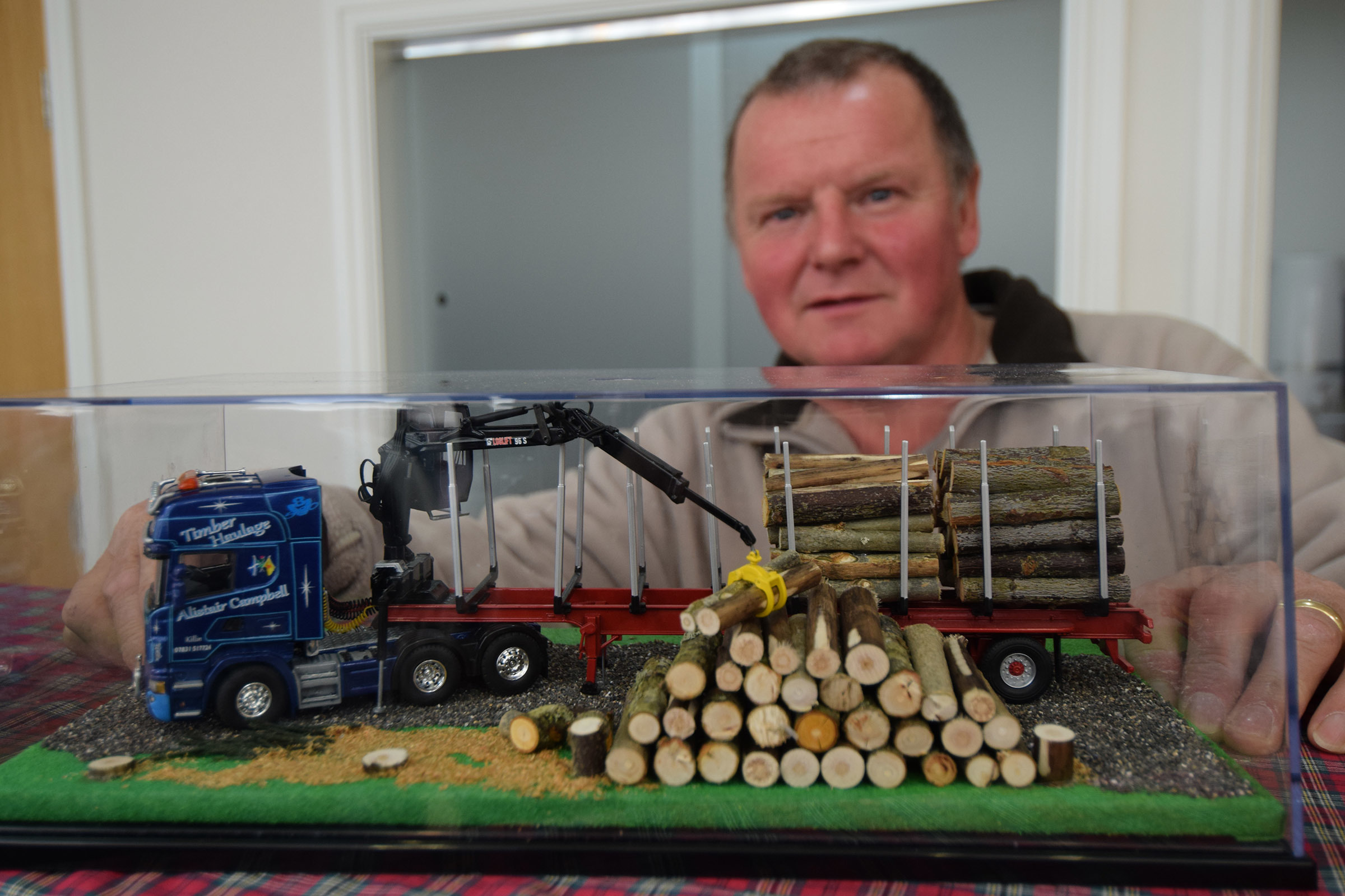 Organiser Robert Wilson with his model of a truck used by local timber haulier Alistair Campbell