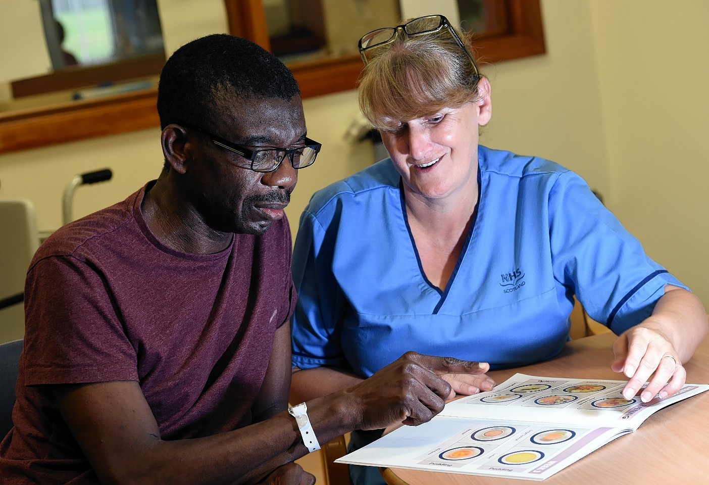 Patient Tony Ebireri discussing the pictorial menu with Snr Staff Nurse Elsie Edwards. Picture by Kami Thomson
