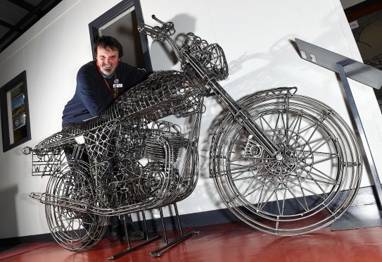 Curator Mike Ward with the sculpture of a Norton Commando Fastback. Picture by Kevin Emslie