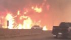 The wildfire rages along Highway 63 in Fort McMurray, Alberta (Tyler Burgett/AP)