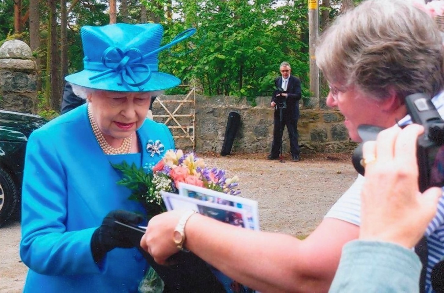 Sheila Clark shows the Queen some of her photos