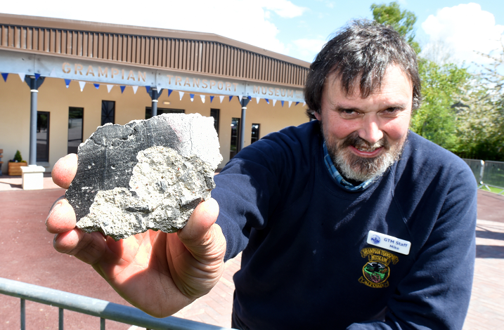 Curator Mike Ward with a piece of the Berlin Wall at the Grampian Transport Museum, Alford.