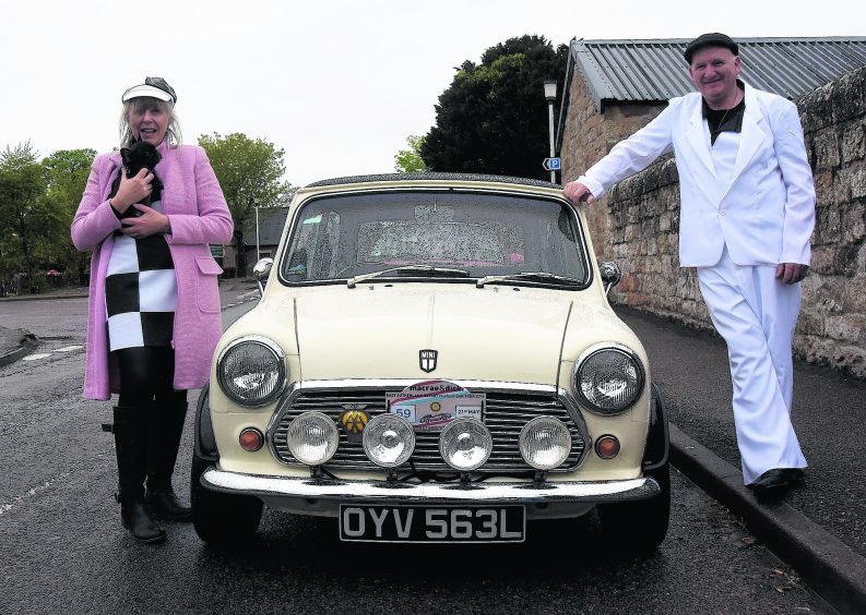 Julie Board and Jim McCue in their sixties gear and Julie's 1972 Austin Mini.