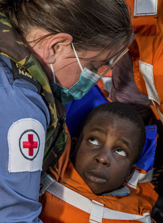Global Operations Category: Royal Navy Medical Assistant Morwenna Nichols, caring for 4 year Milako Izic, who has just been rescued. PO (Phot) Carl Osmond